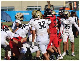 A group of football players on a field. Description generated by AI
