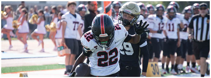 A football player wearing a blue and white uniform. Description generated by AI
