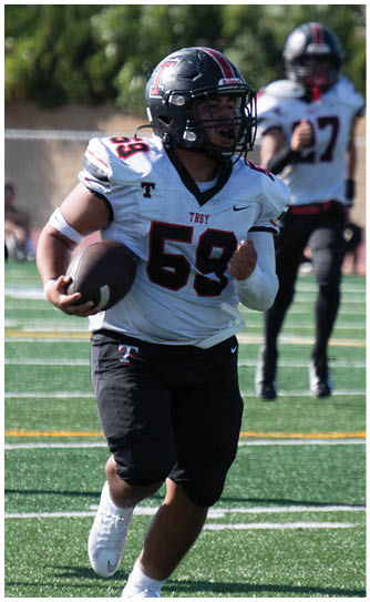 A football player catching a ball. Description generated by AI
