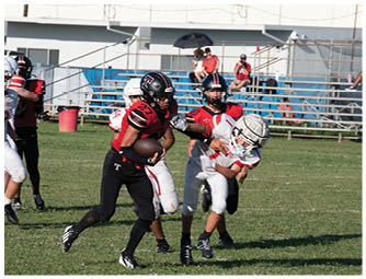 A group of football players on a field. Description generated by AI
