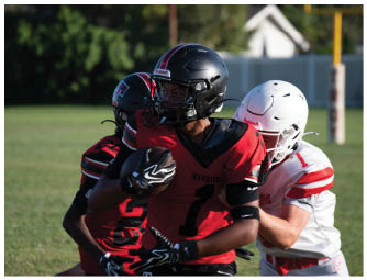 A group of football players on a field. Description generated by AI