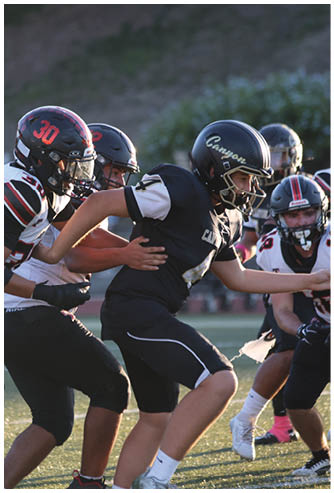 A football game is being played on a field. Description generated by AI