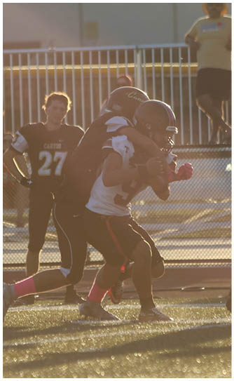 A football player catching a ball. Description generated by AI