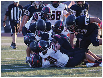 A group of football players on a field. Description generated by AI