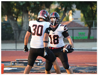 A group of football players on a field. Description generated by AI