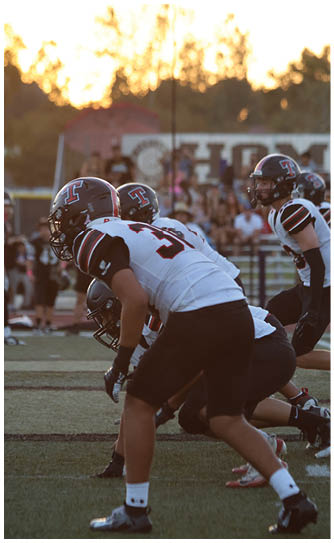 A football player catching a ball. Description generated by AI