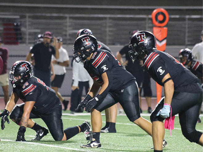 A group of football players in black and white uniforms are on the field. AI generated content