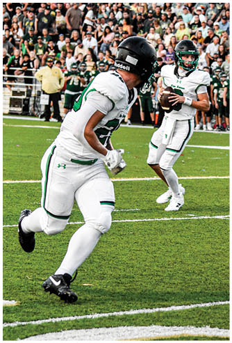 A football player running on the field. Description generated by AI