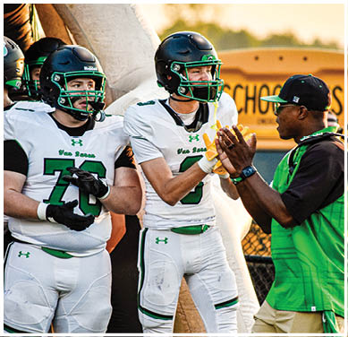 A football game is taking place with a group of men on the field. Description generated by AI