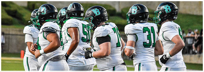 A group of football players on a field. Description generated by AI