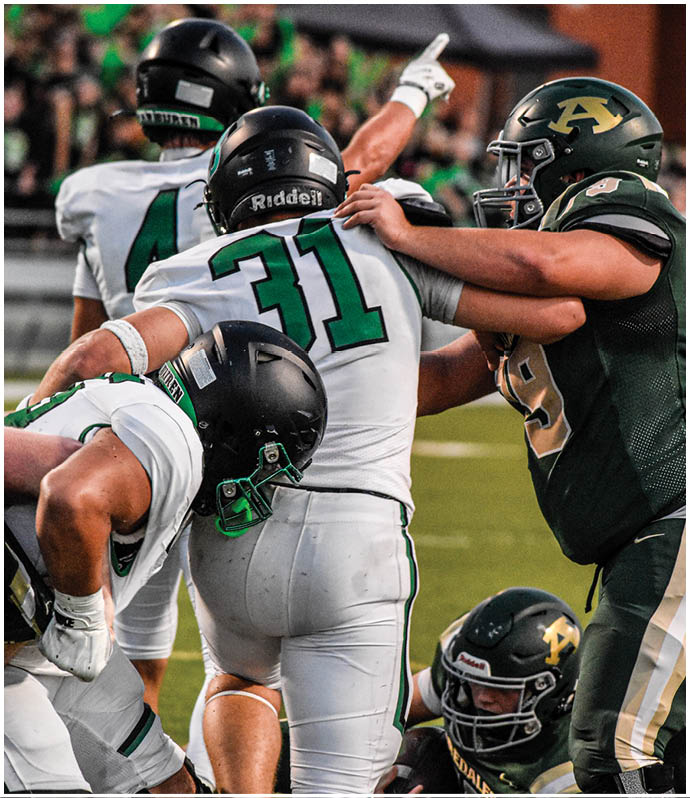 A group of football players wearing black and white uniforms. Description generated by AI