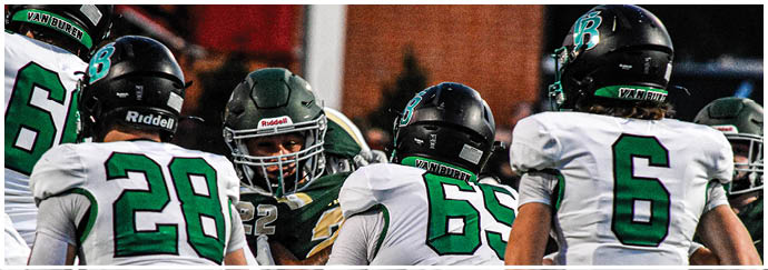A group of football players on a field. Description generated by AI