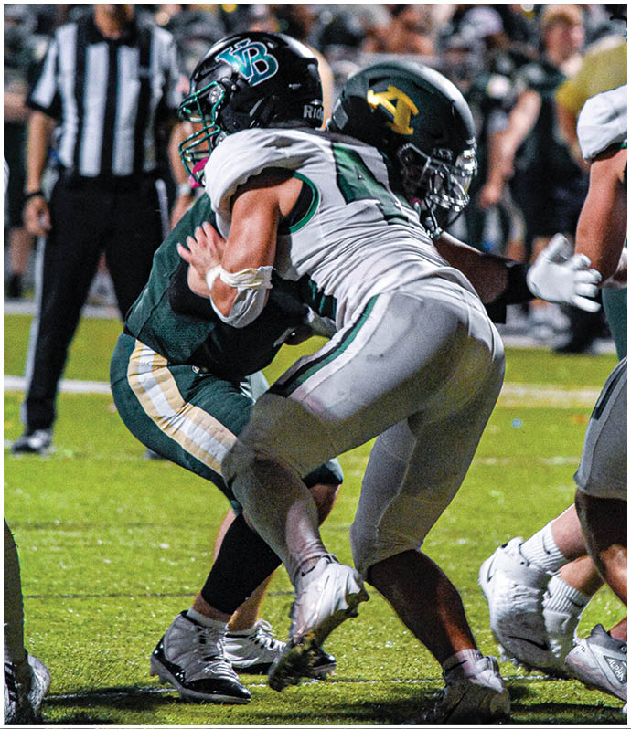 A group of football players wearing black and white uniforms. Description generated by AI
