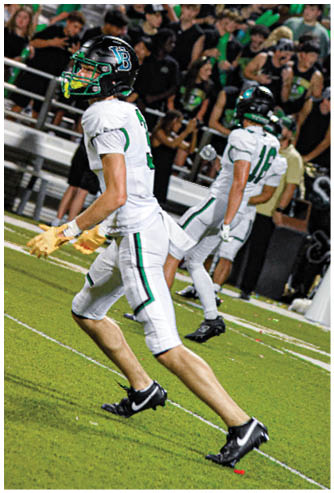 A football player running on the field. Description generated by AI