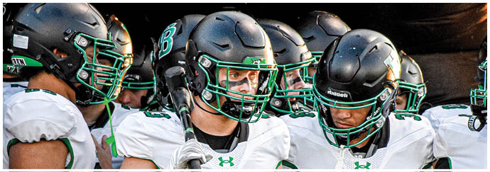 A group of football players on a field. Description generated by AI