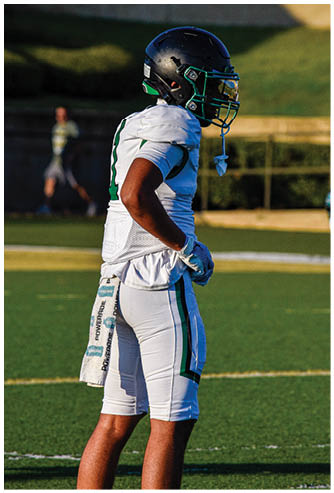 A football player running on the field. Description generated by AI