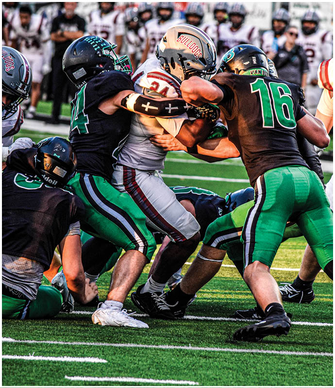A group of football players wearing black and white uniforms. Description generated by AI