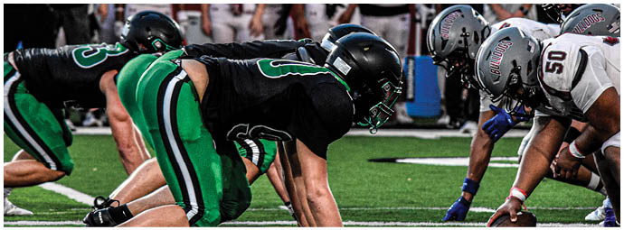 A football player is sliding on the ground. Description generated by AI
