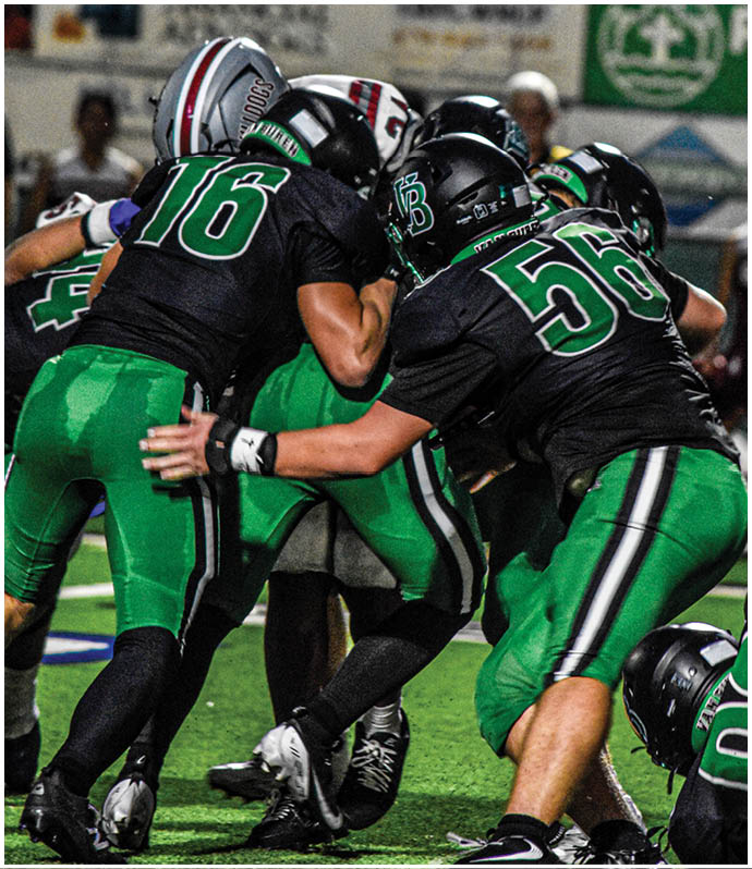 A group of football players wearing black and white uniforms. Description generated by AI