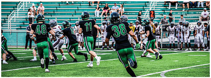 A football player is sliding on the ground. Description generated by AI