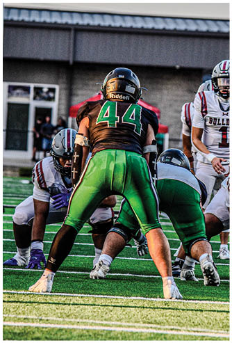 A football player running on the field. Description generated by AI
