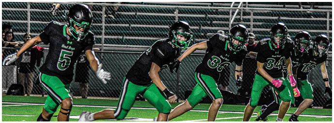 A football player is sliding on the ground. Description generated by AI