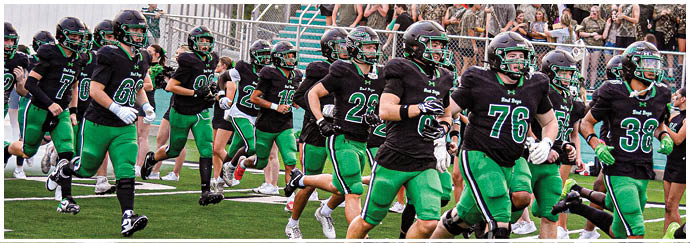 A group of football players on a field. Description generated by AI