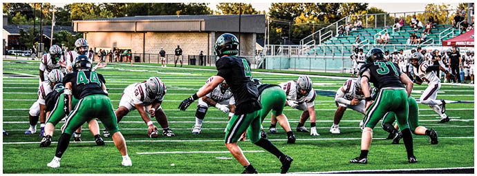 A football player is sliding on the ground. Description generated by AI