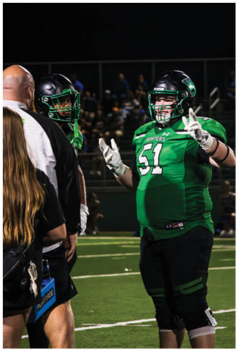 A football player running on the field. Description generated by AI