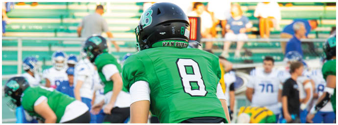 A football player is sliding on the ground. Description generated by AI