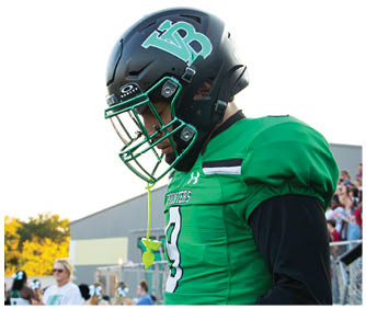 A football player running on the field. Description generated by AI