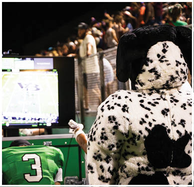 A football game is taking place with a group of men on the field. Description generated by AI