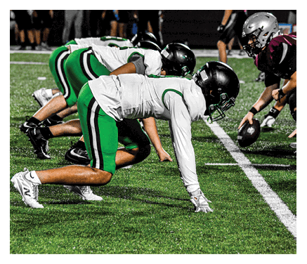 A man wearing a football uniform is jumping to catch a football. AI generated content