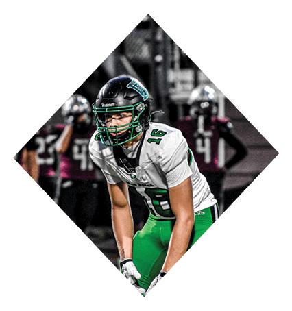 A football player wearing a black jersey with the number 3 kneels on the field. AI generated content