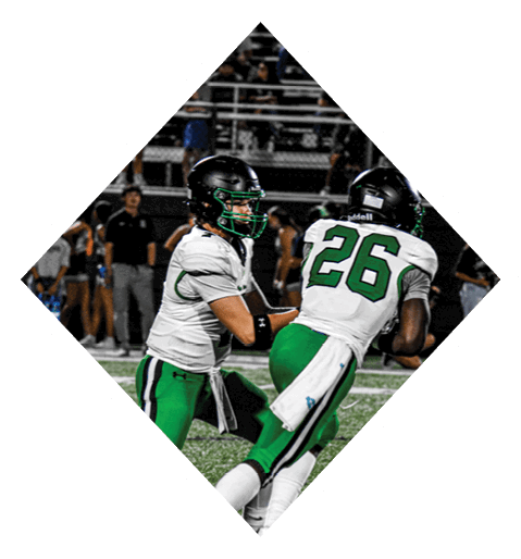 A football player wearing a black jersey with the number 10 sits on the ground with a football helmet on the ground next to him. AI generated content