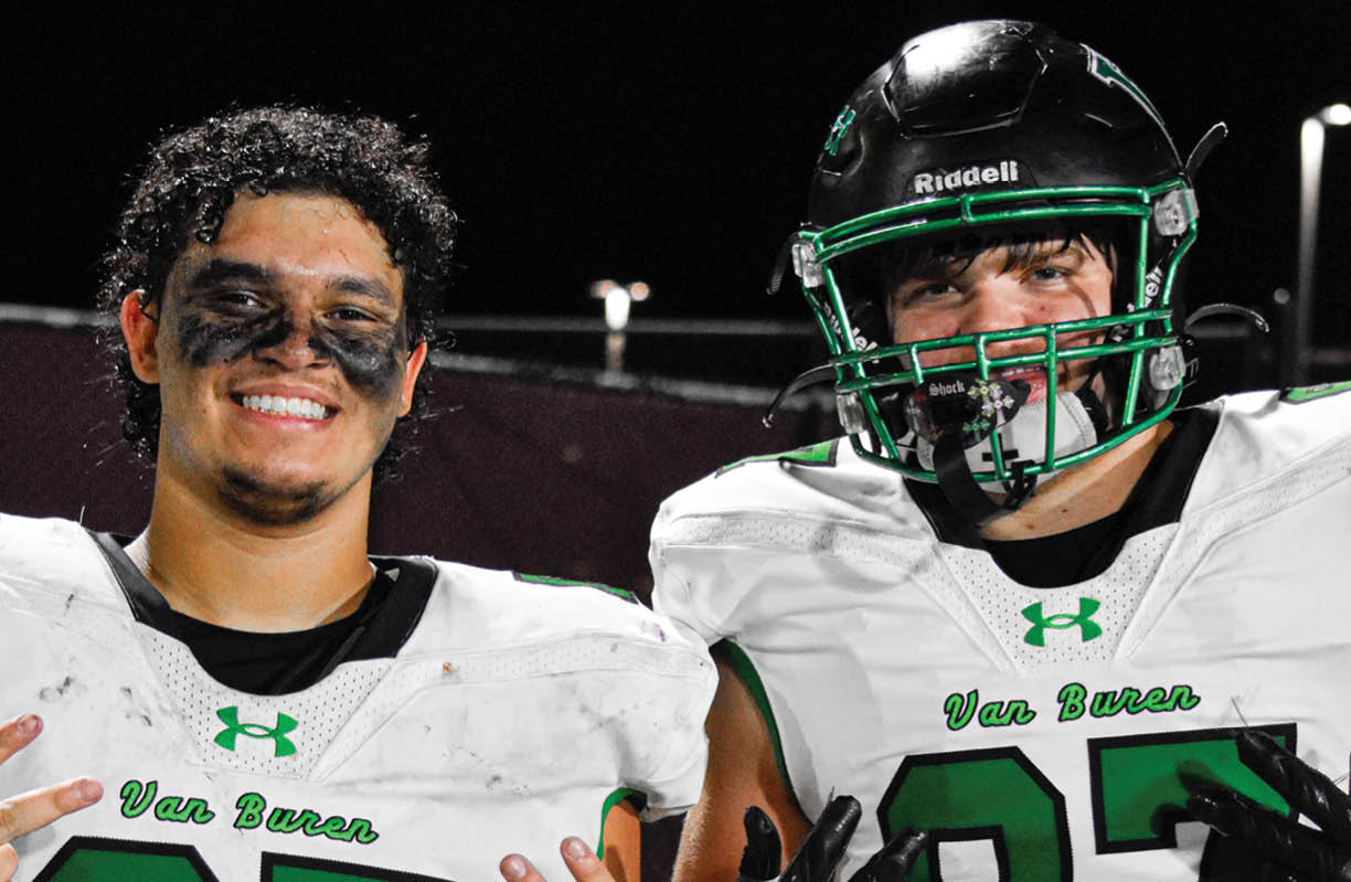 A man with a green shirt and a football jersey is wearing a black face mask. AI generated content