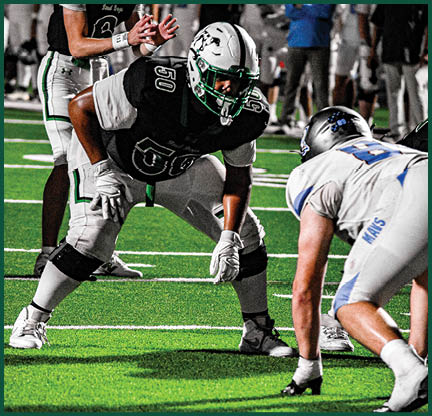 Two football players with black and white uniforms and black face paint. Description generated by AI