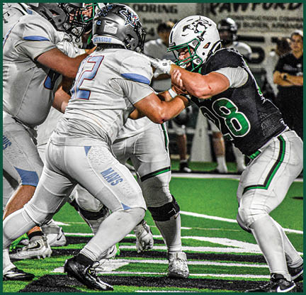 The football players are wearing black and white uniforms. Description generated by AI