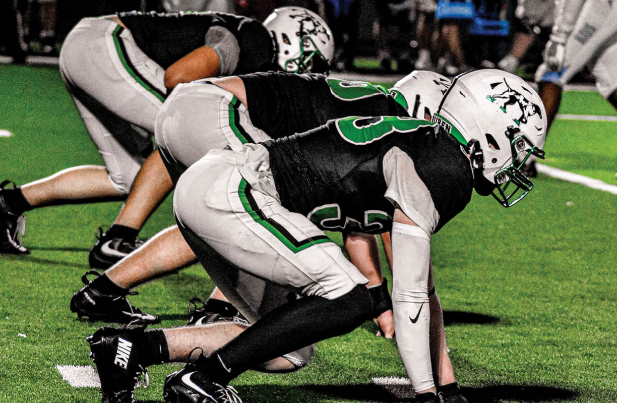 A man with a green shirt and a football jersey is wearing a black face mask. AI generated content