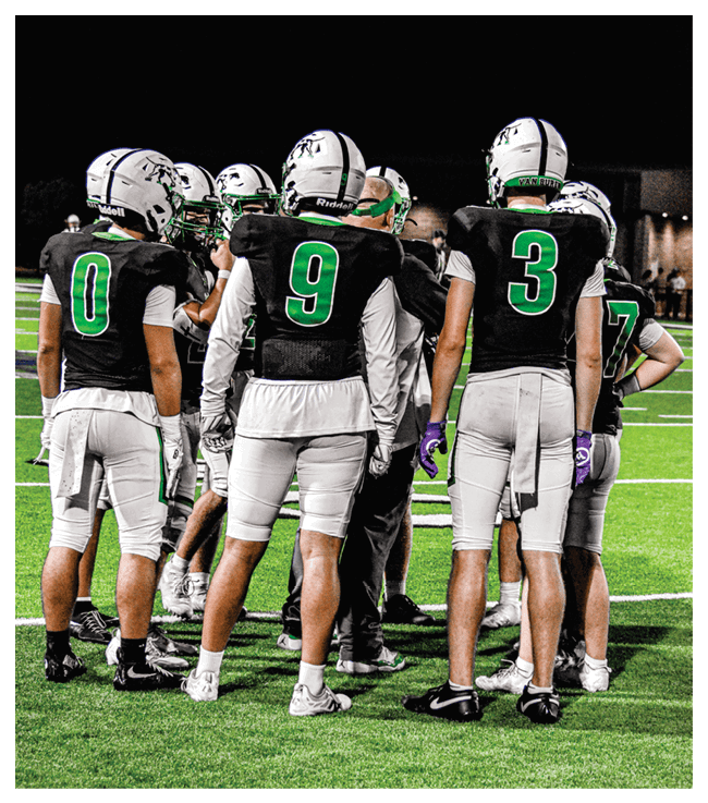 A group of football players walking on the field. AI generated content