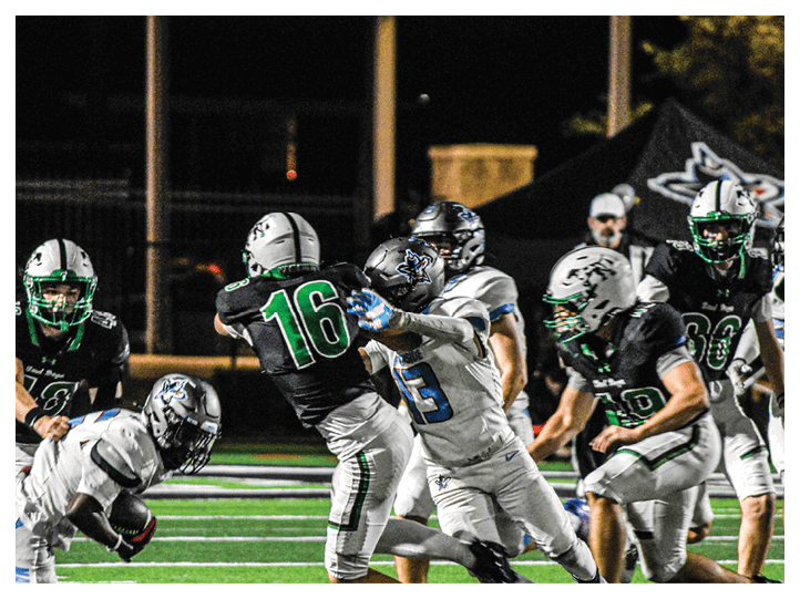 A group of football players on a field, one of them is running with a football. AI generated content