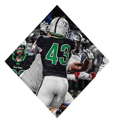 A female football player is kicking a football on a field. AI generated content