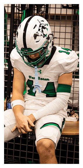 A man in a green shirt and black pants is preparing to throw a football. AI generated content
