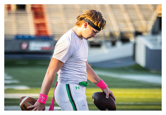A group of people are kneeling on a field, possibly in a football game. AI generated content