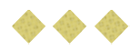 Three yellow diamond-shaped crackers with small holes are arranged in a horizontal row on a white background. Description generated by AI