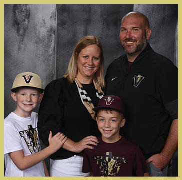 Five people wearing matching striped polo shirts and one person in a black shirt pose together against a dark, textured backdrop. Description generated by AI