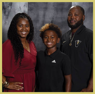 Five people wearing matching striped polo shirts and one person in a black shirt pose together against a dark, textured backdrop. Description generated by AI