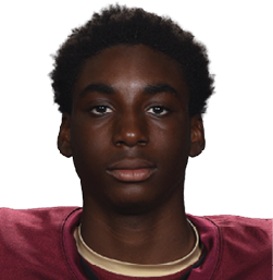 Person wearing a maroon football jersey with the number 28 and the word Vidalja on the front, standing against a white background. Description generated by AI