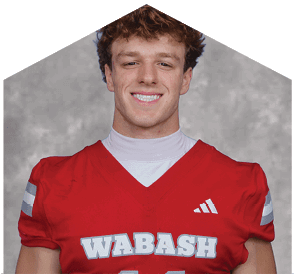 A young man wearing a white jersey with the number 10 on it. Description generated by AI