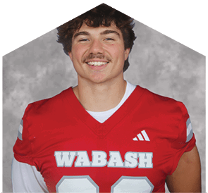 A young man wearing a white jersey with the number 10 on it. Description generated by AI